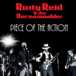 Rusty Reid – “Piece of the Action”
